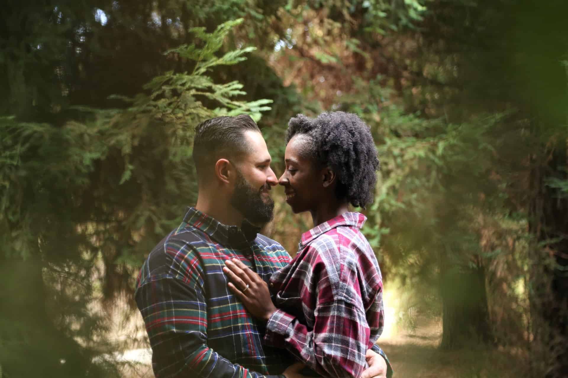 Photo of a multicultural couple holding each other in a loving moment. Multicultural Therapy help you heal and learn new skills to cope with the stress and loss that can come with immigration and adjusting to a new country and life.