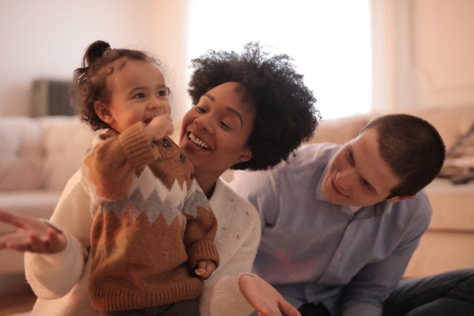 Photo of a interracial family in a happy loving moment. This represents how relationship counseling for individuals can work to help you build healthy and positive relationships and find happiness.