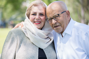 Photo of an older couple holding each other. This represents how a relationship therapist can help couples cope with the loss of the familiar because of immigration and recreating a new identity, by embracing the differences between the two worlds.