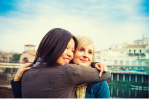 Photo of a multicultural lesbian couple. Thos represents how couples counseling can help you and your partner reconnect and work toward the same goals.