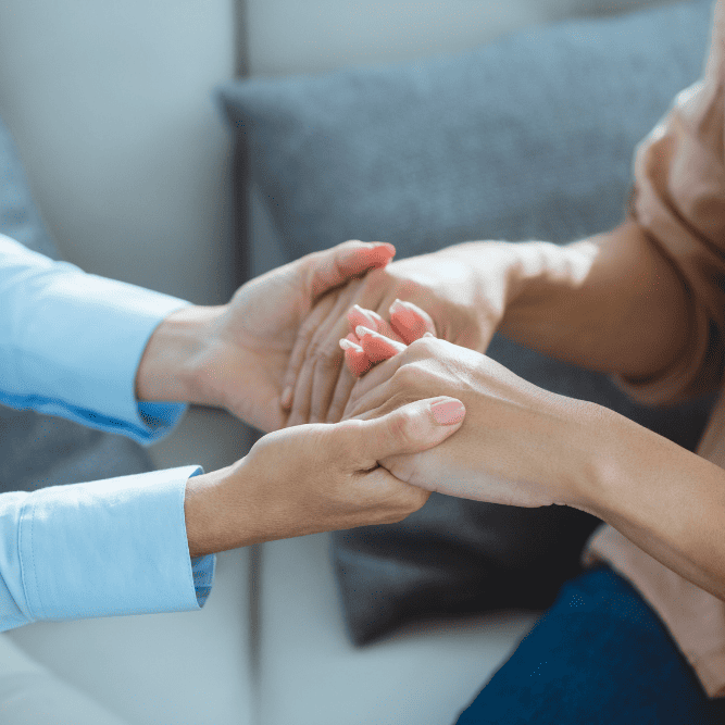 Photo of two people holding hands. This represents how finding a therapist in North Carolina or Virginia can help you move toward the life you want and achieve your goals.