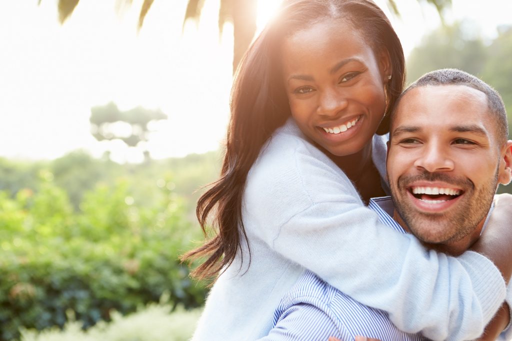 Photo of a couple holding each other and smiling. This represents how a online therapy in North Carolina and Virginia can help couples rediscover connection and intimacy.