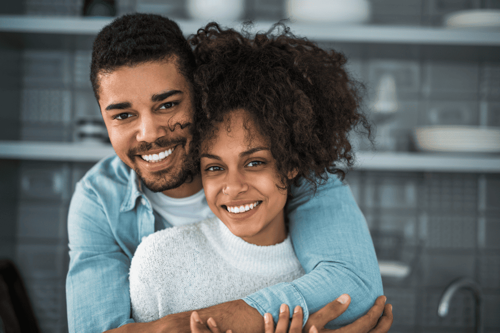 Photo of a happy couple holding each other. This represents the benefits of relationship counseling and how it can help you work toward a happy relationship, whether you are in a relationship or single.
