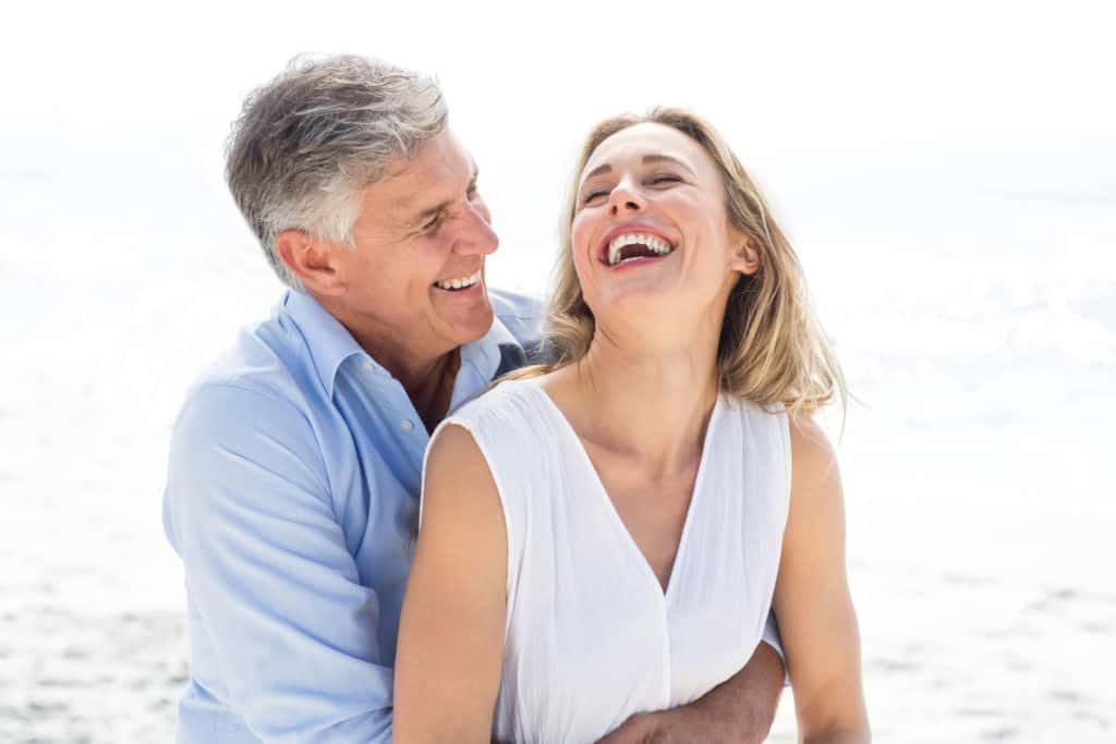 Photo of a couple laughing together. Many new empty-nesters struggle with this transition period after the kids leave the house. Talking with one of our therapists experienced in working with couples going through similar empty nest syndrome symptoms can help you feel listened to and understood.