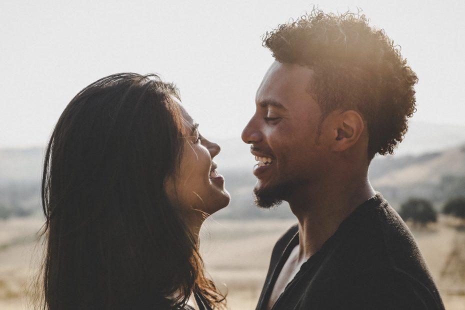 Photo of a multiracial couples looking at each other and smiling. Learn 4 Tips for more effective cross-cultural communication.